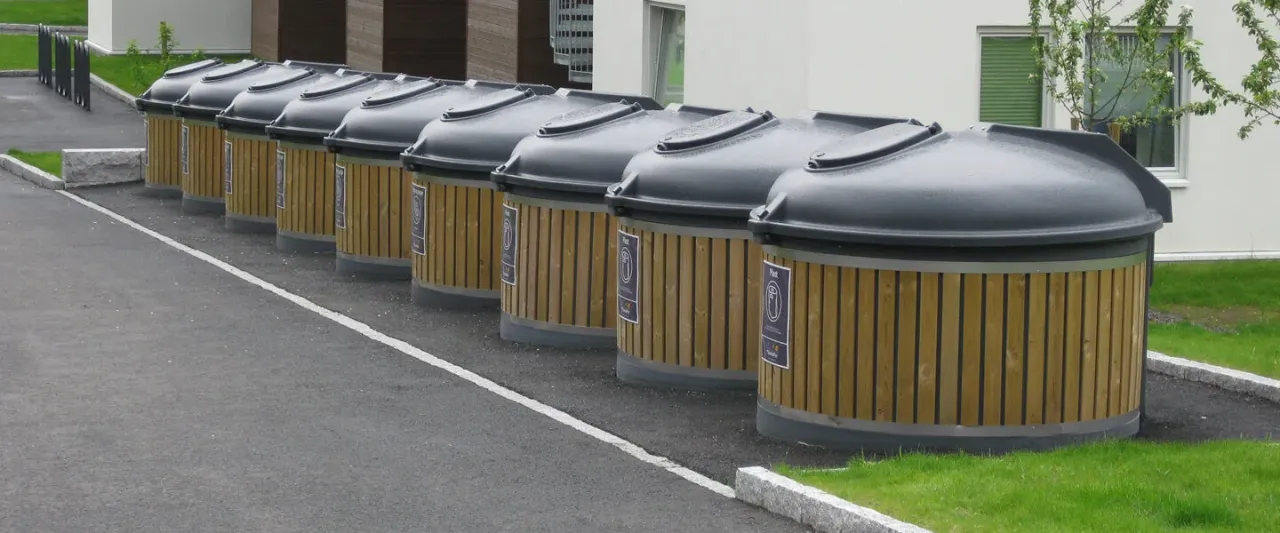 Semi-underground recycling island with polyethylene waste containers