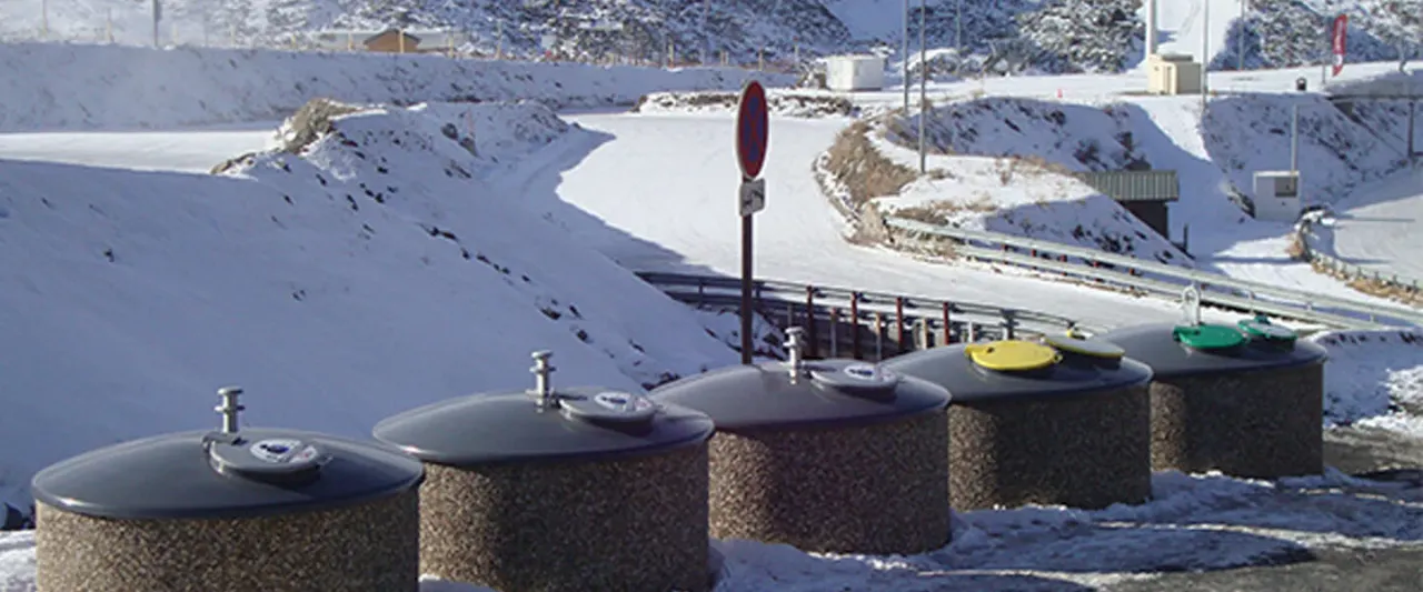 Semi-underground steel waste containers with concrete shell in an urban setting